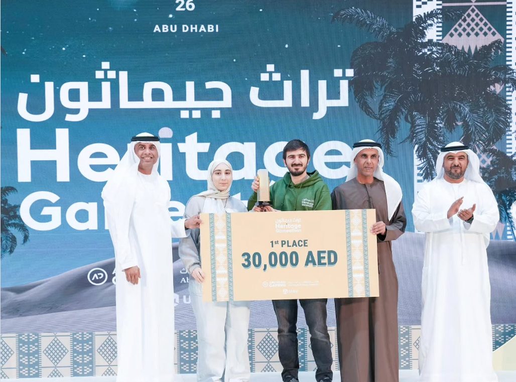 The first-place team on stage receiving their trophy and cheque.